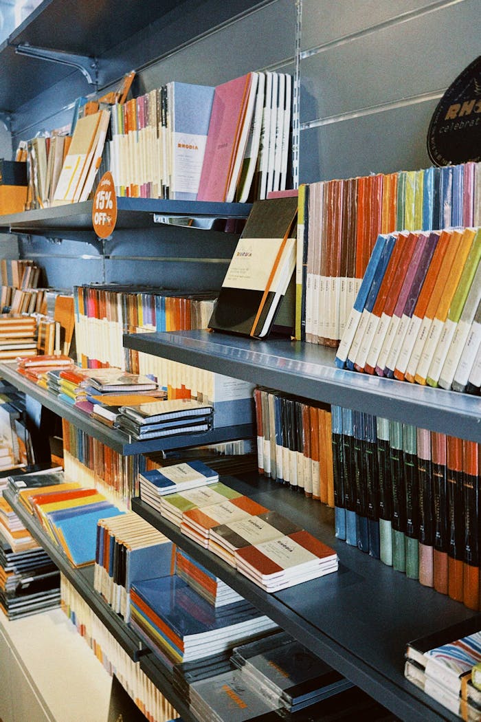 Vibrant bookshelves showcasing a diverse collection of colorful notebooks in a retail store.